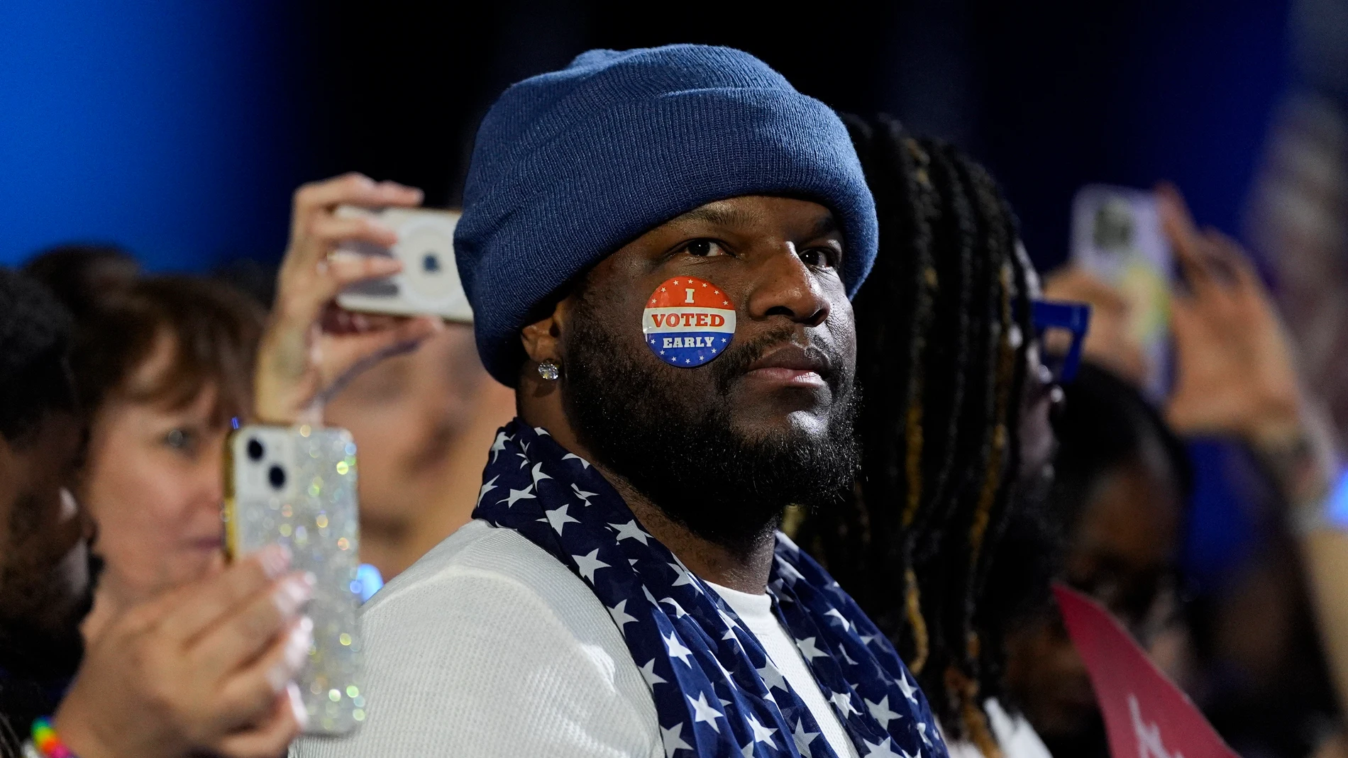 A supporter wears an "I Voted Early" sticker on his face during a campaign rally for Democratic presidential nominee Vice President Kamala Harris at the Wisconsin State Fair Expo in West Allis, Wis., Friday, Nov. 1, 2024. (AP Photo/Jacquelyn Martin)