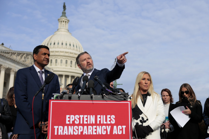 Los representantes Ro Khanna, Thomas Massi y Marjorie Taylor Greene en una conferencia de prensa con el Capitolio de los Estados Unidos al fondo.